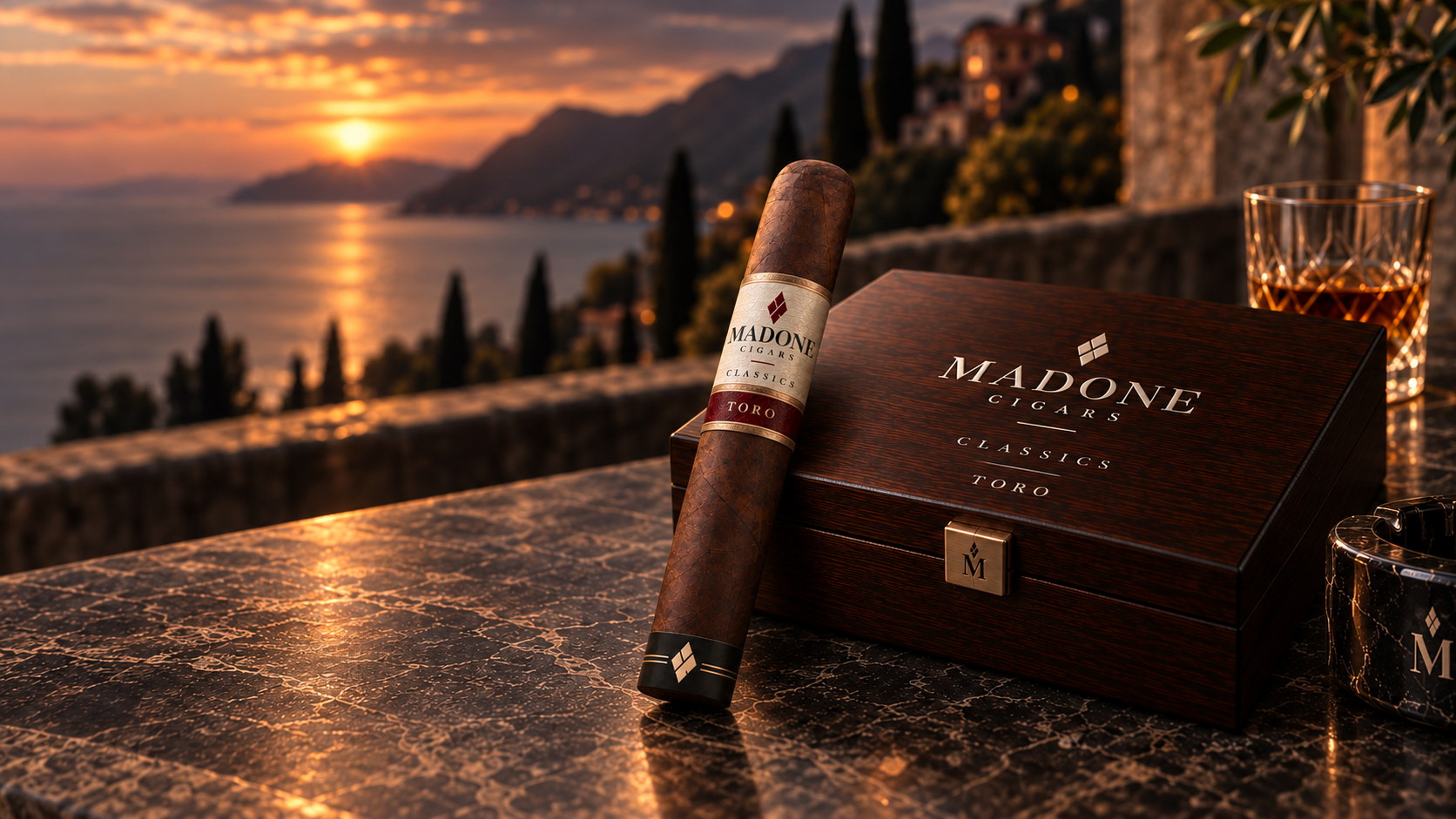 A Madone Classics Toro cigar leaning against its Classics Toro box on a terrace at sunset.